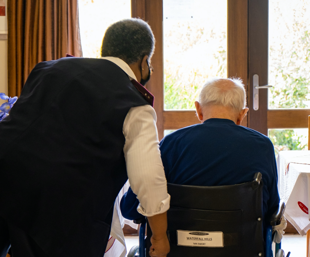 Caregiver pushing resident on a wheelchair