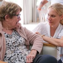 lady with care worker at old age home
