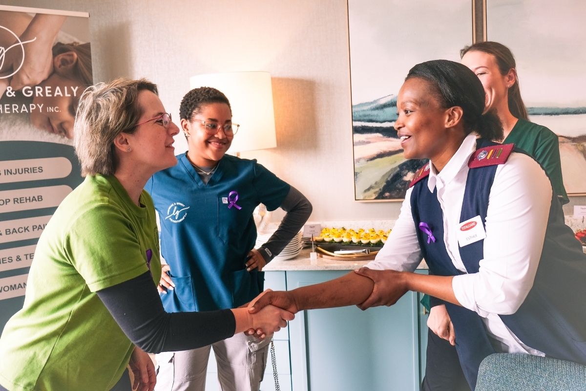 A TOTALCARE team member greeting a visitor