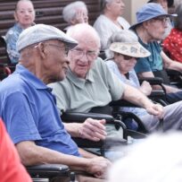 Two old men in wheelchairs at old age home
