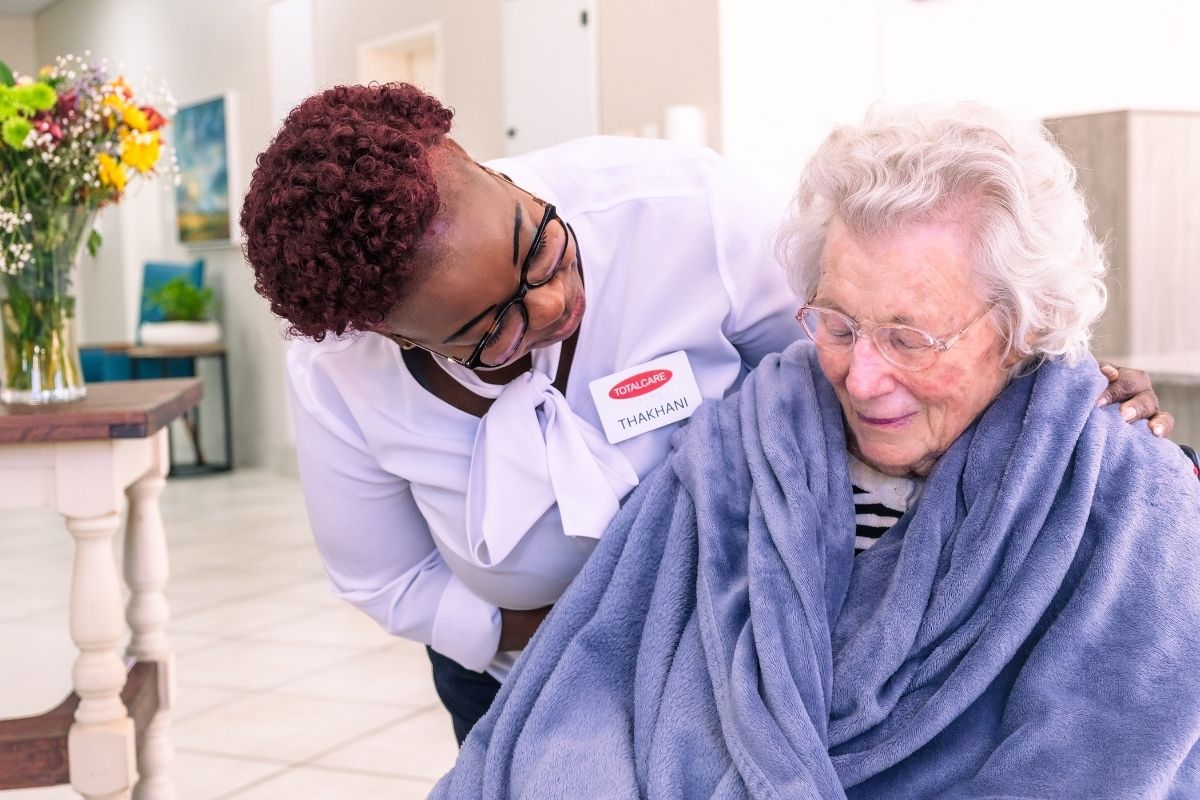 A TOTALCARE carer sharing a warm moment with a resident