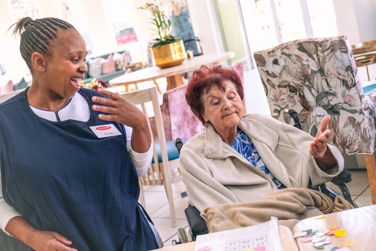 A TOTALCARE carer and resident sharing a cheerful moment